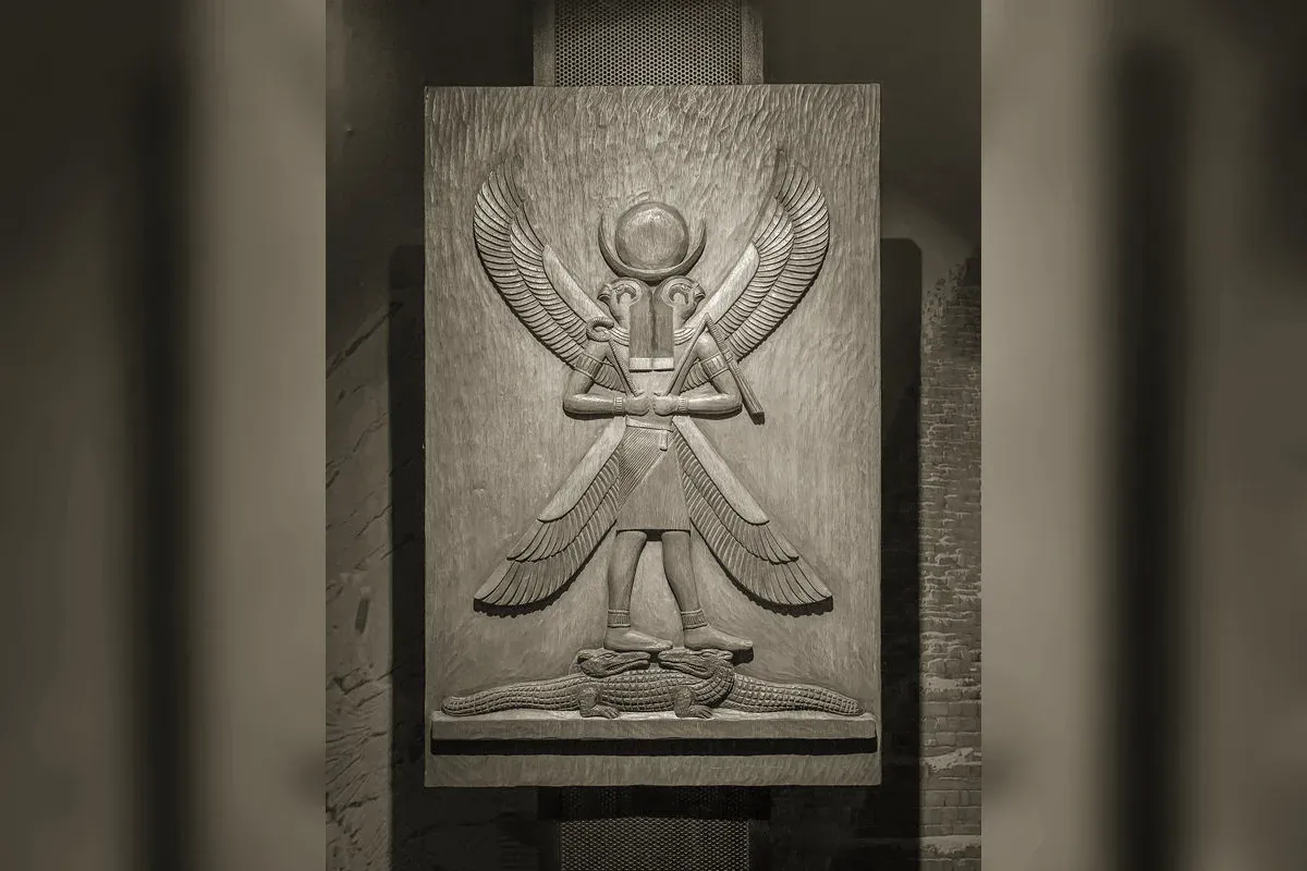 Horus with a falcon head wearing the double crown, holding the was-sceptre