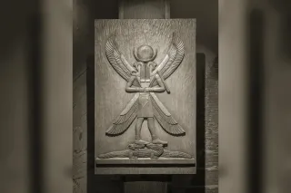 Horus with a falcon head wearing the double crown, holding the was-sceptre